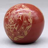 A miniature red seed pot decorated with a two panel sgraffito geometric design, click or tap to see a larger version