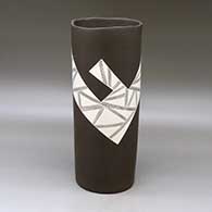 A white on brown cylinder with an organic rim and decorated with a fineline and geometric design
 by Diego Valles of Mata Ortiz and Casas Grandes