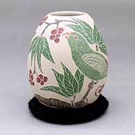 A polychrome jar decorated with a sgraffito and painted bird, branch, leaf and berry design
 by Guadalupe Melendez of Mata Ortiz and Casas Grandes