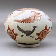A polychrome jar decorated with a lightly carved, sgraffito and painted turtle, roadrunner, grasshopper, lightning bolt and geometric design, click or tap to see a larger version