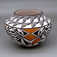 A polychrome jar decorated with a four panel fine line and geometric design below the shoulder and a geometric design above
 by Lucy Lewis of Acoma