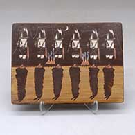 A rectangular polychrome tile decorated with a Night Chant Dancer and geometric design
 by Ida Sahmie of Dineh