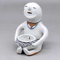 A polychrome Cochiti rain god with a bowl in his lap and decorated with a geometric design
 by Martha Arquero of Cochiti
