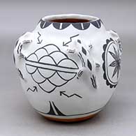 A classic Cochiti polychrome jar with four lizard applique handles and decorated with a four panel lightning bolt, rain cloud, medallion, feather and geometric design
 by Martha Arquero of Cochiti