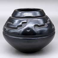 A black jar carved with a stylized avanyu design above the shoulder
 by Margaret Tafoya of Santa Clara
