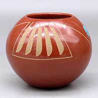 A red jar decorated with a two panel sgraffito feather and geometric design plus two inlaid pieces of turquoise
 by Tony Da of San Ildefonso