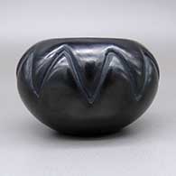 Black jar with a carved geometric design, click or tap to see a larger version