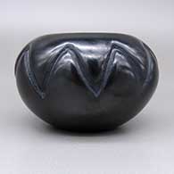 Black jar with a carved geometric design, click or tap to see a larger version