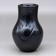 A black vase carved with two bear paw imprints
 by Toni Roller of Santa Clara