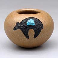 Click for a larger view A small golden micaceous bowl decorated with a sgraffito and painted black bear with an inlaid turquoise
by Russell Sanchez of San Ildefonso
