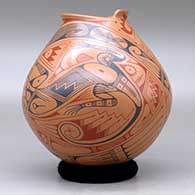 A polychrome jar with a geometric cut opening and decorated with a two panel lizard and geometric design, click or tap to see a larger version