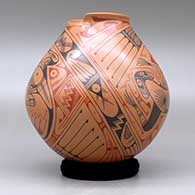A polychrome jar with a geometric cut opening and decorated with a two panel lizard and geometric design, click or tap to see a larger version
