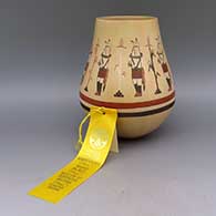 Polychrome jar with dancer, cornstalk, feather, and geometric design, includes 3rd Place ribbon from the 1996 Heritage Program Marketplace at the Museum of Northern Arizona in Flagstaff
 by Ida Sahmie of Dineh