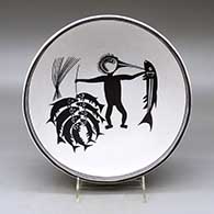 A black on white bowl decorated inside with a Mimbres replica of the Fisherman design
 by Barbara and Joseph Cerno Sr of Acoma