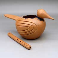 The woodpecker and flute, a black on golden micaceous bird effigy and clay flute, from the Chickasaw
 by Marcella Yepa of Jemez