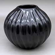 A black melon jar decorated with 24 repousse ribs
 by Helen Shupla of Santa Clara