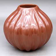 A red melon jar decorated with 17 repousse ribs
 by Helen Shupla of Santa Clara
