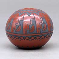 A polychrome seed pot decorated with a medallion of rain clouds and a kiva step, rain cloud and geometric design, click or tap to see a larger version