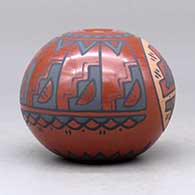 A polychrome seed pot decorated with a medallion of rain clouds and a kiva step, rain cloud and geometric design, click or tap to see a larger version