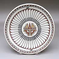 A shallow polychrome bowl decorated with a rain cloud, kiva step, ring of feathers and geometric design
 by Minnie Vigil of Santa Clara