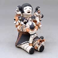 A sitting grandmother storyteller figure with eight children, pets and a pot
 by Marilyn Ray of Acoma