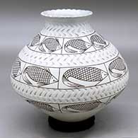 A black on white jar with a recurved neck and notched rim, decorated with bands of corrugation and bands of fish with geometric design
 by Dora Quezada of Mata Ortiz and Casas Grandes