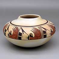 A polychrome low shouldered jar decorated with a four-panel bird element and geometric design above the shoulder
 by Fawn Navasie of Hopi