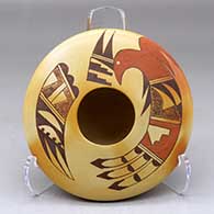 A polychrome flat top jar decorated with fire clouds and painted on top with a bird element and geometric design
 by Garrett Maho of Hopi