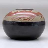 A black seed pot decorated with a sgraffito avanyu design in a wide band of sienna below the opening, click or tap to see a larger version