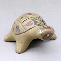 A polychrome turtle decorated with dancer, animal, insect and geometric designs
 by Margaret and Luther Gutierrez of Santa Clara