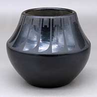 A black on black jar decorated with a band of feather design above the shoulder
 by Desideria Montoya of San Ildefonso
