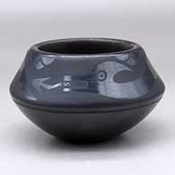 A black on black bowl decorated above the shoulder with an avanyu and geometric design
 by Blue Corn of San Ildefonso