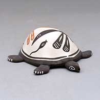 A polychrome turtle figure decorated with a dragonfly, tadpole and geometric design
 by Carlos Laate of Zuni