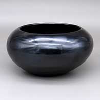 A plain polished black bowl
 by Maria Martinez of San Ildefonso