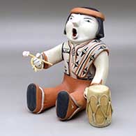 A singing drummer with drum and drumstick
 by Ada Suina of Cochiti