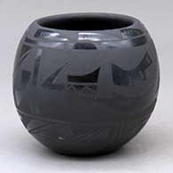 A black on black jar decorated with an avanyu and geometric design around the body
 by Birdell Bourdon of Santa Clara