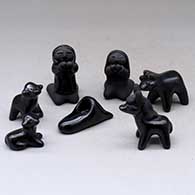 A miniature seven-piece matte and polished black Nativity set
 by Dorothy and Paul Gutierrez of Santa Clara