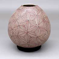 A polychrome jar decorated all over with a geometric design
 by Juan Quezada Jr of Mata Ortiz and Casas Grandes