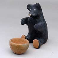 A sitting black bear figure with a red bowl
 by Jo Ann Kaye of Cochiti
