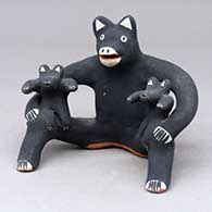 A sitting bear figure with two cubs on his knees
 by Martha Arquero of Cochiti