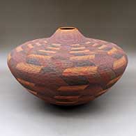 A large, wide tiny coil jar decorated with a sgraffito and painted geometric design
 by Richard Zane Smith of Wyandot