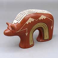 A polychrome bear figure decorated with a lightly carved, sgraffito and painted geometric design
 by Aaron Cajero Jr of Jemez
