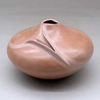 A dark pink seed pot with an organic opening and decorated with an ear of corn applique
 by Iris Nampeyo of Hopi