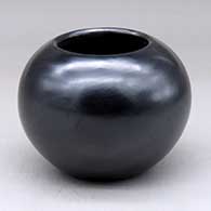 A plain, polished black bowl with fire clouds
 by Maria Martinez of San Ildefonso