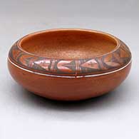 A small polychrome bowl with a golden micaceous interior and decorated above the shoulder with a band of geometric design
 by Nathan Begaye of Hopi