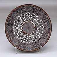 A polychrome plate decorated with a North Star, fineline and geometric design
 by Rebecca Lucario of Acoma