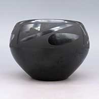 Black bowl with four panel geometric design, click or tap to see a larger version