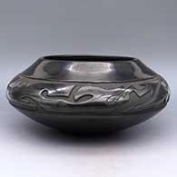 Low shoulder black jar with carved avanyu design
 by LuAnn Tafoya of Santa Clara