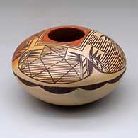 A polychrome seed pot decorated with fire clouds and a four-panel migration pattern and geometric design
 by Adelle Nampeyo of Hopi