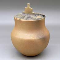 A lidded golden micaceous pot decorated with fire clouds
 by Lonnie Vigil of Nambe